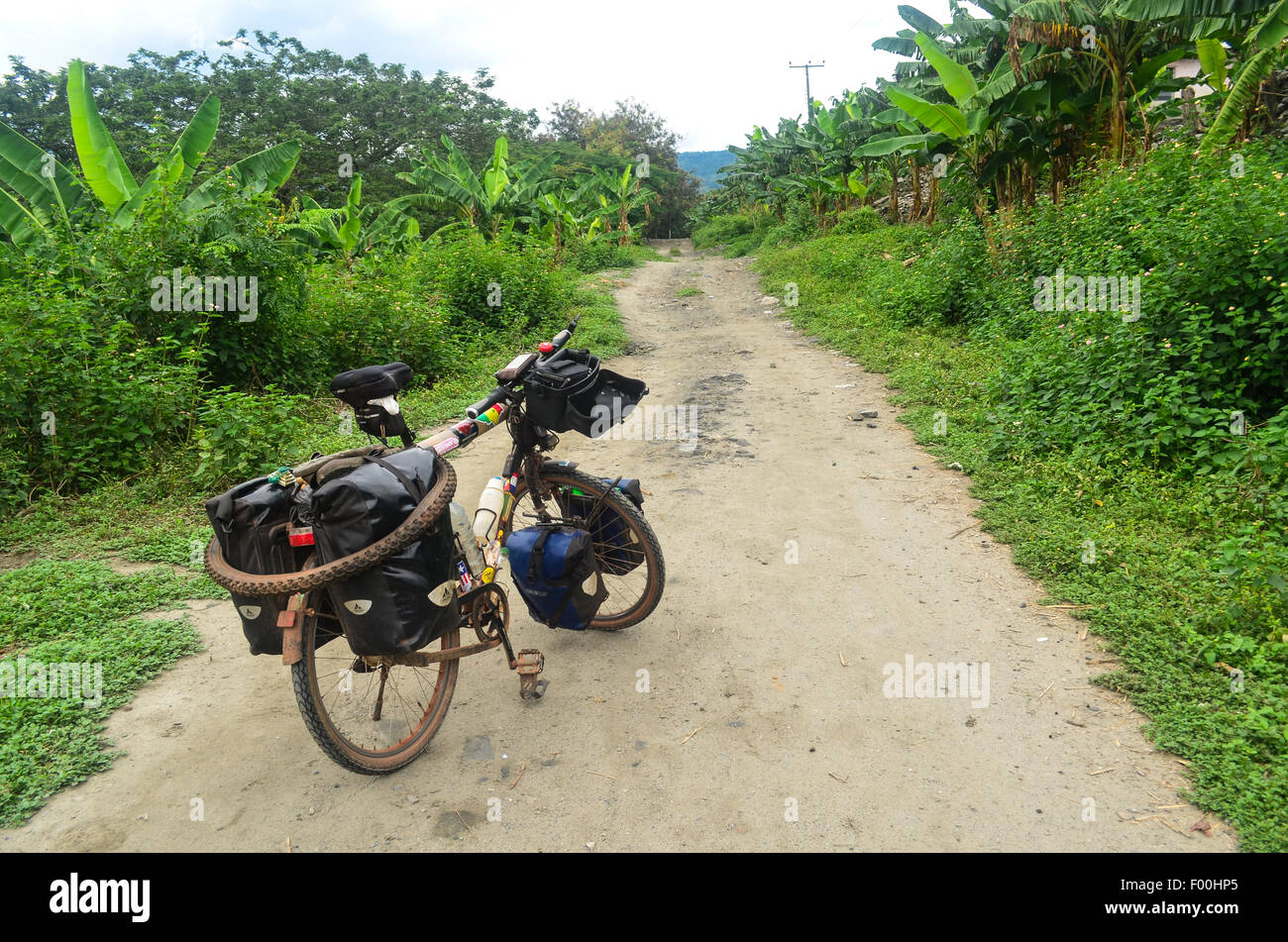 Touring bicycle on a dirt road into the Ghanaian countryside, around the lake Bosomtwe near Kumasi Stock Photo