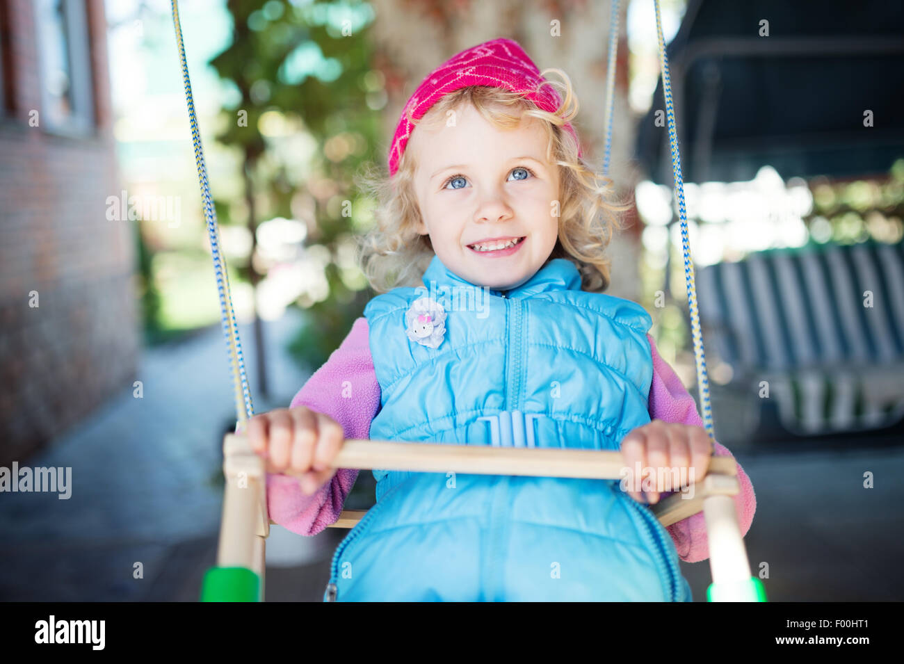 Laughing little girl on swing Stock Photo