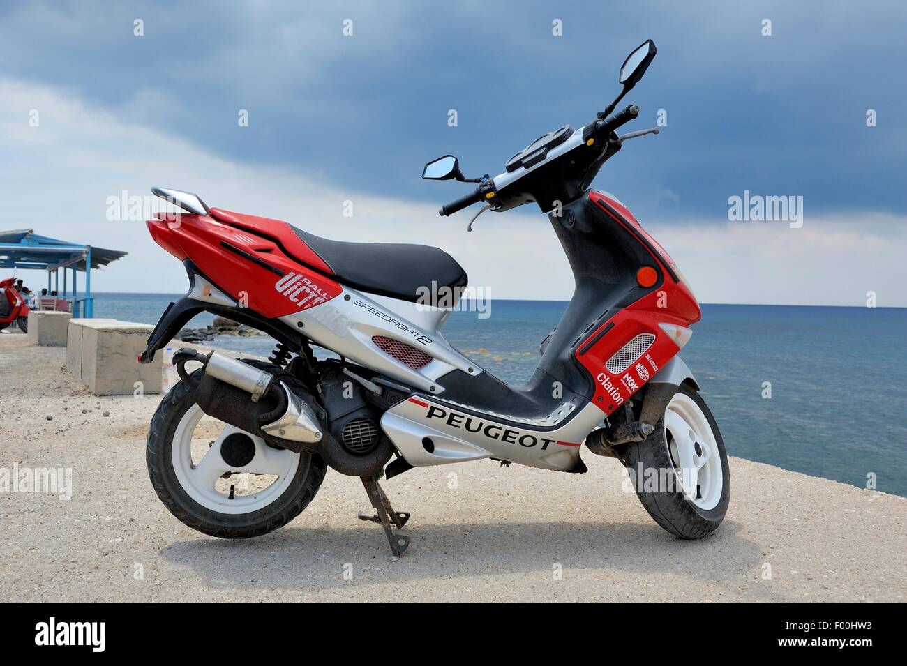 A Peugeot speedfight 2 french scooter parked on the seafront