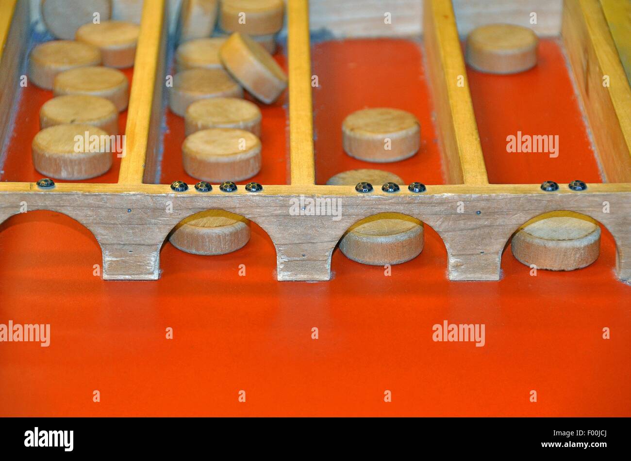 Dutch shuffleboard game with wooden puck on bright orange color Stock Photo Alamy