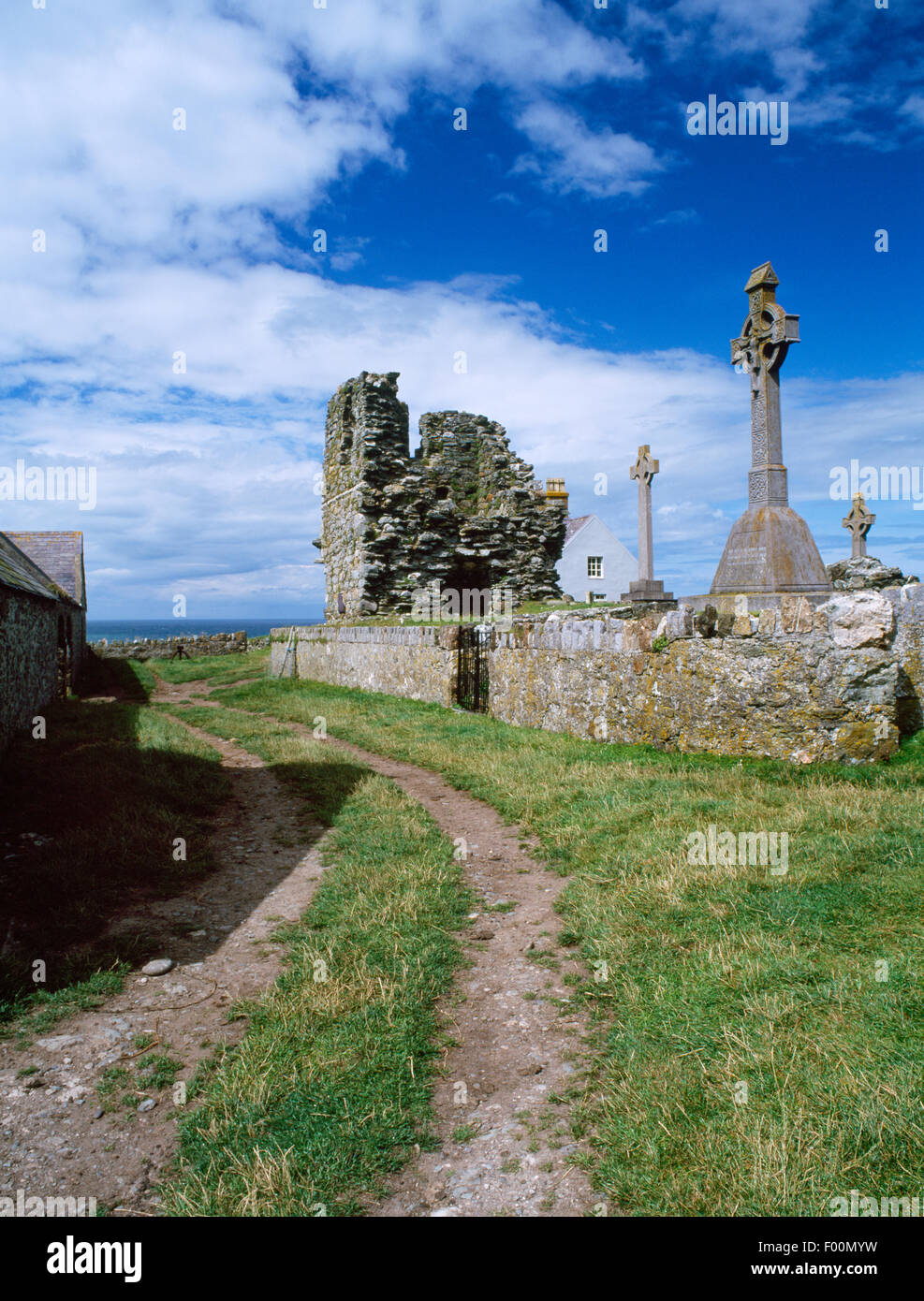 Trackway, graveyard & ruined tower of St Mary's Abbey at N end of Bardsey Island, Gwynedd. Founded by AD1200 on a C6th Celtic monastic site. Stock Photo