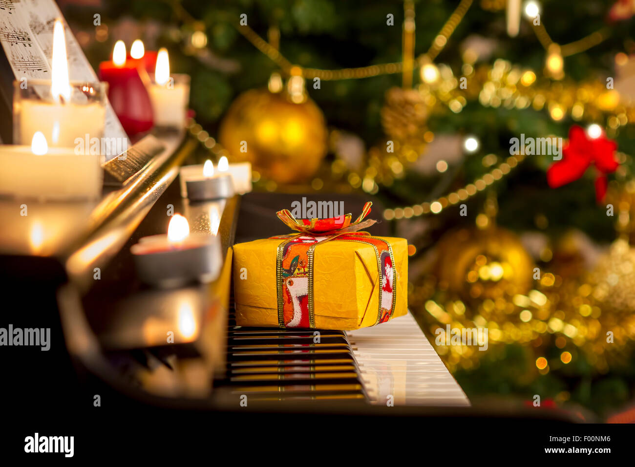 Christmas gift on piano. Christmas decoration with gift on piano. Stock Photo