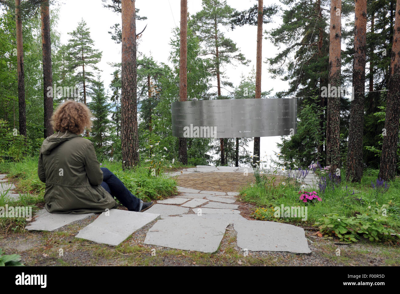 Utoya, Norway. 5th Aug, 2015. A woman sits in front of the ring-shaped