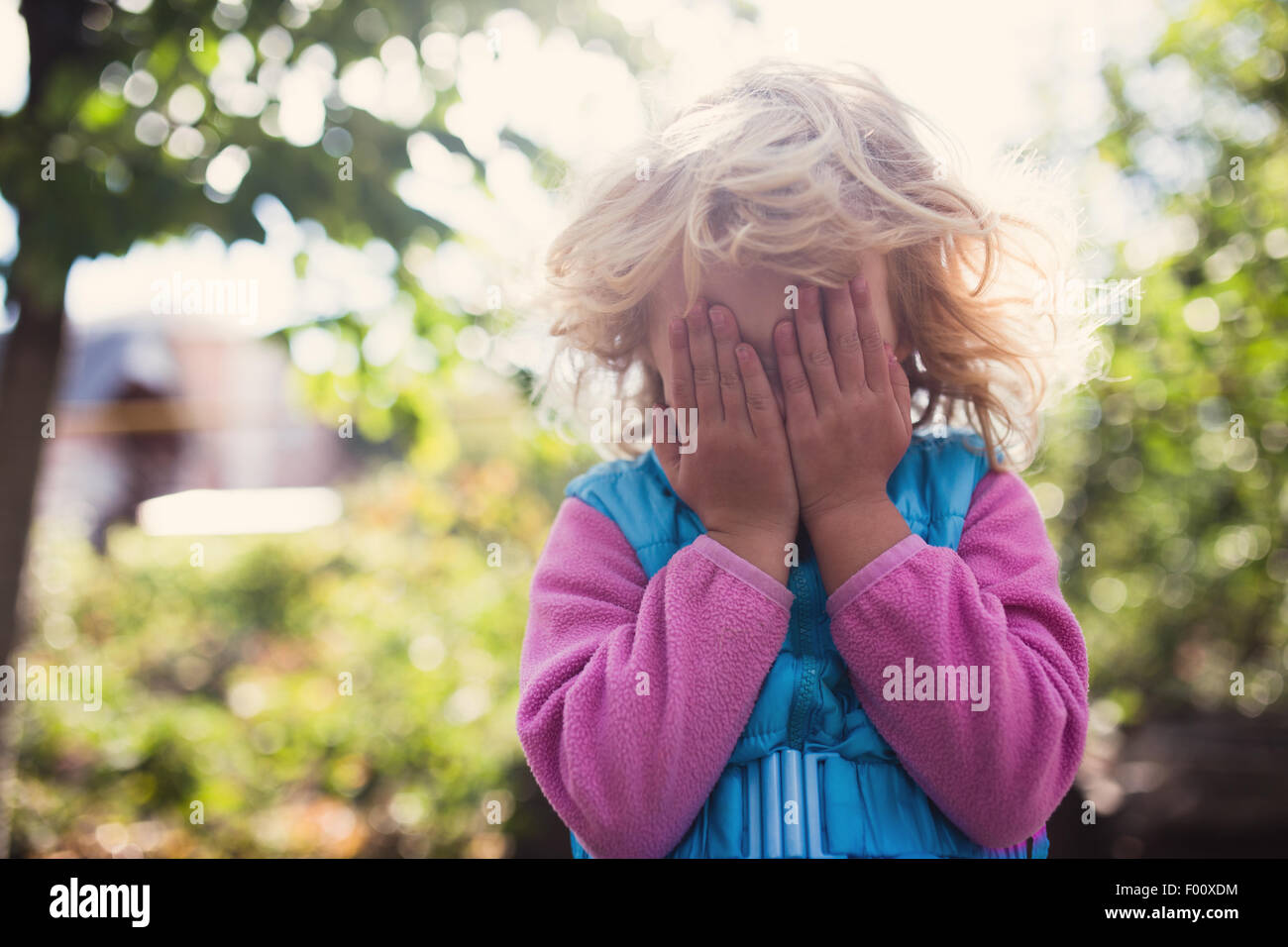 Portrait of cute blonde little girl playing outdoors Stock Photo - Alamy