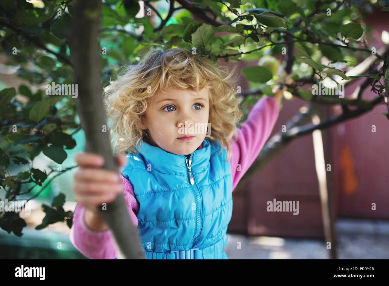 Portrait of cute blonde little girl playing outdoors Stock Photo - Alamy