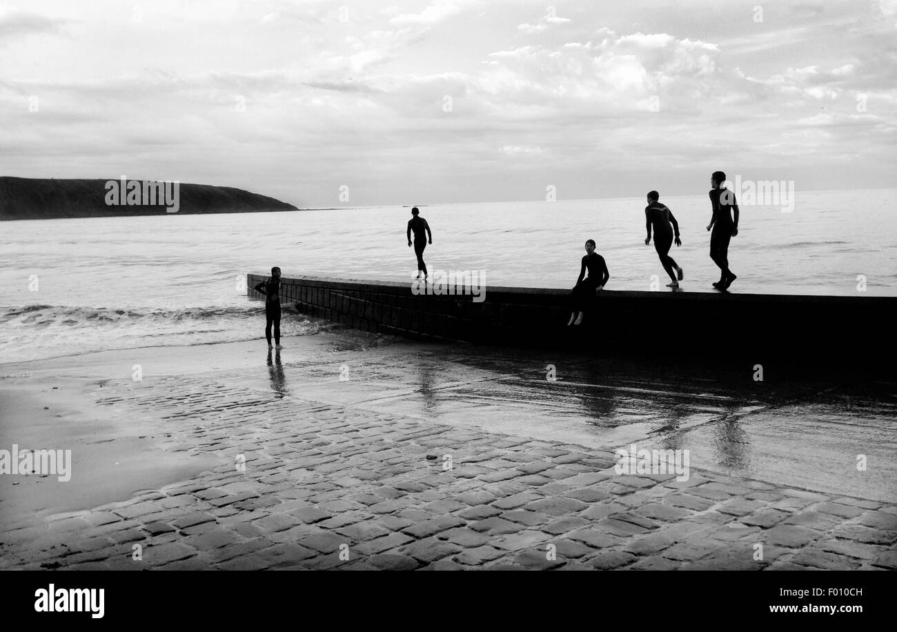 boys swiming at the black sea Boys swimming in their wetsuits at cobble Landing, Filey, North Yorkshire,  UK. Picture: Scott Bairstow/Alamy Stock Photo - Alamy