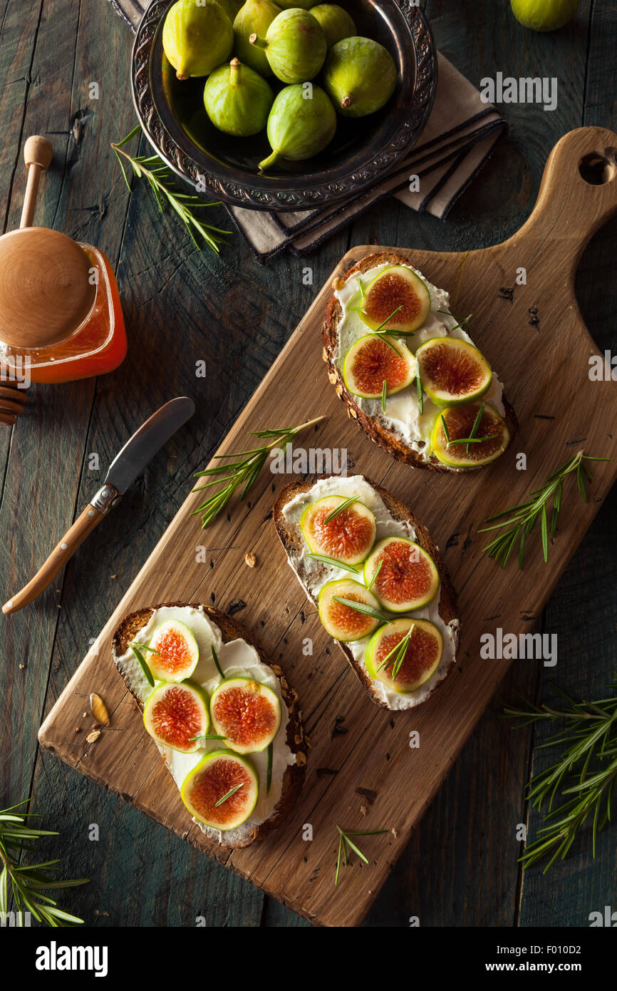 Homemade Fig and Goat Cheese Toast with Rosemary and Honey Stock Photo