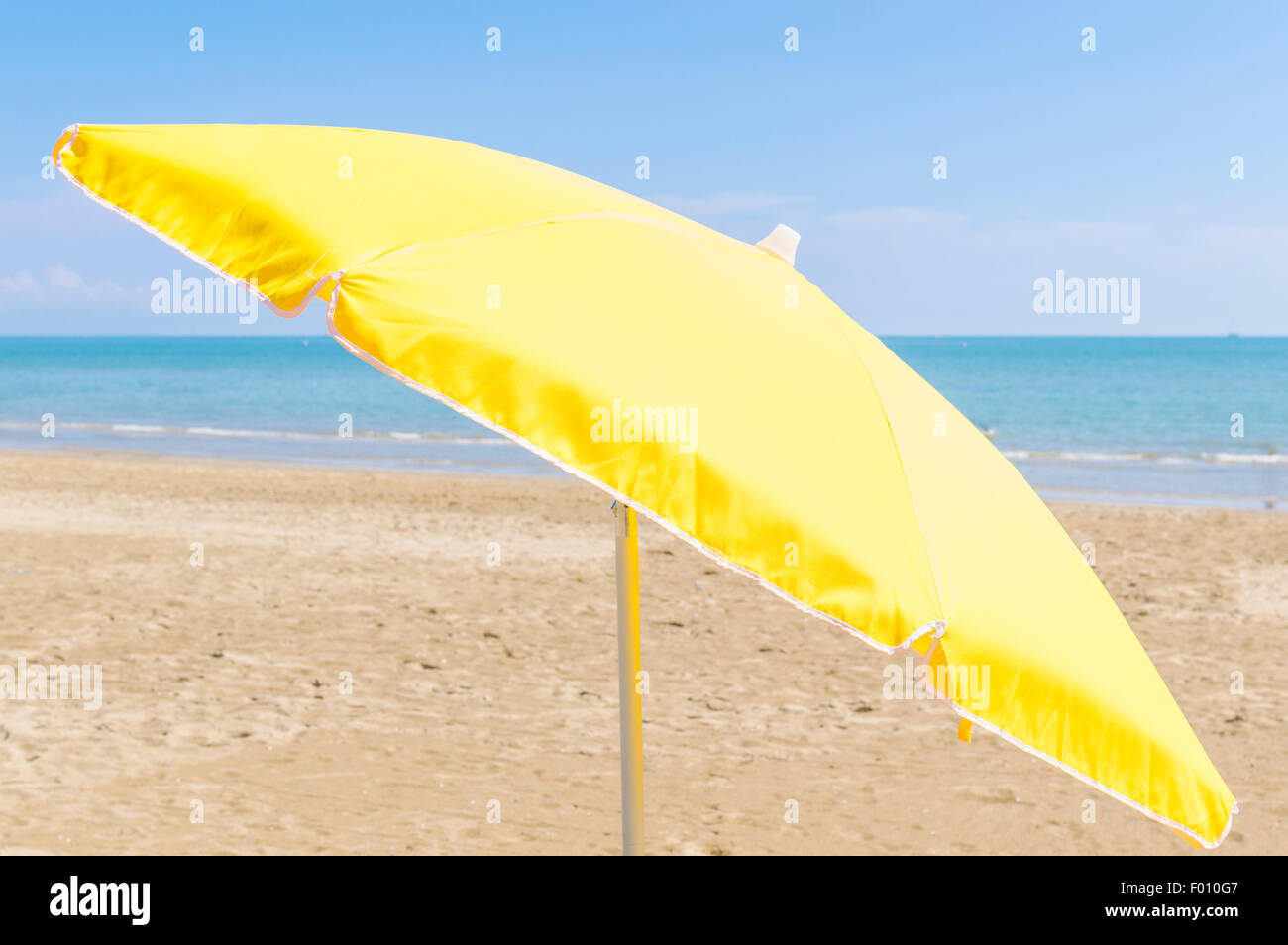 Umbrella on the beach, with the sea and sky in the background Stock Photo