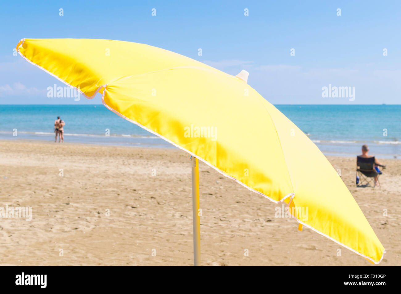 Umbrella on the beach, with the sea and sky in the background Stock Photo