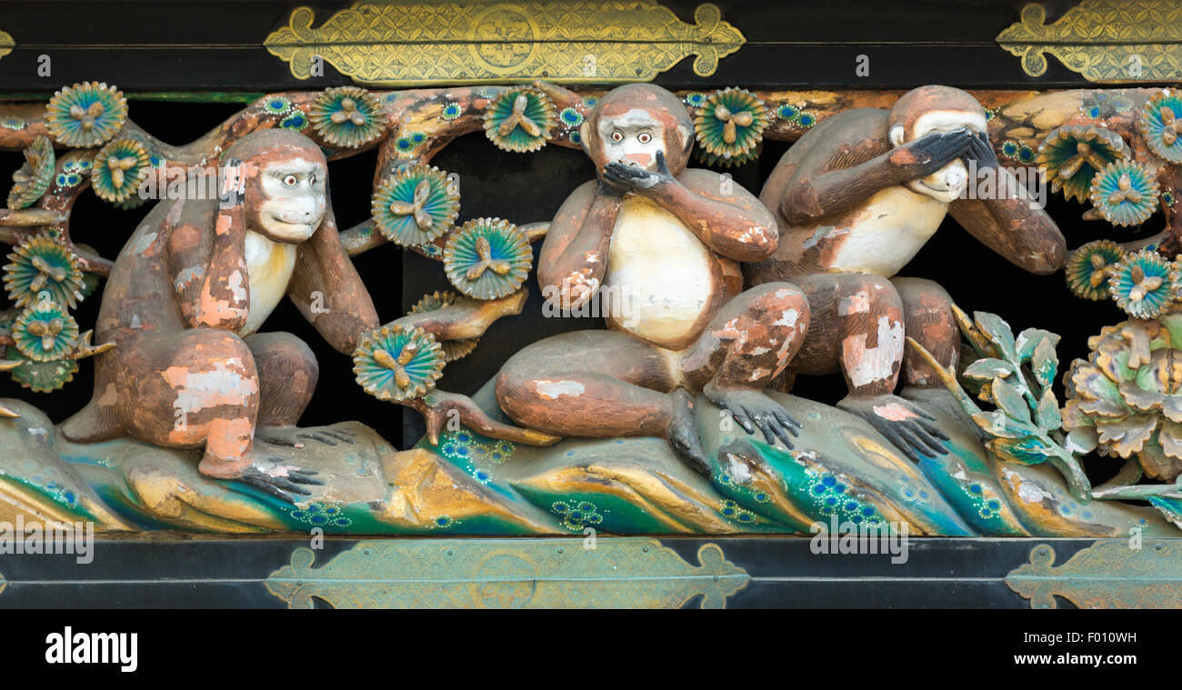 Hear No Evil, Speak No Evil, See No Evil wood carving of monkeys above the Shinkyusha (sacred stable) for horses in Nikko Japan Stock Photo