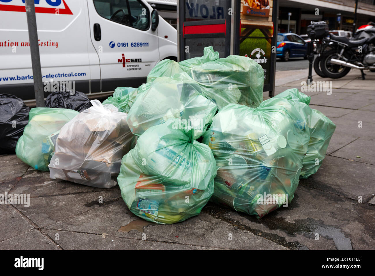 rubbish piled up in bin bags on the footpath awaiting council collection Manchester England UK