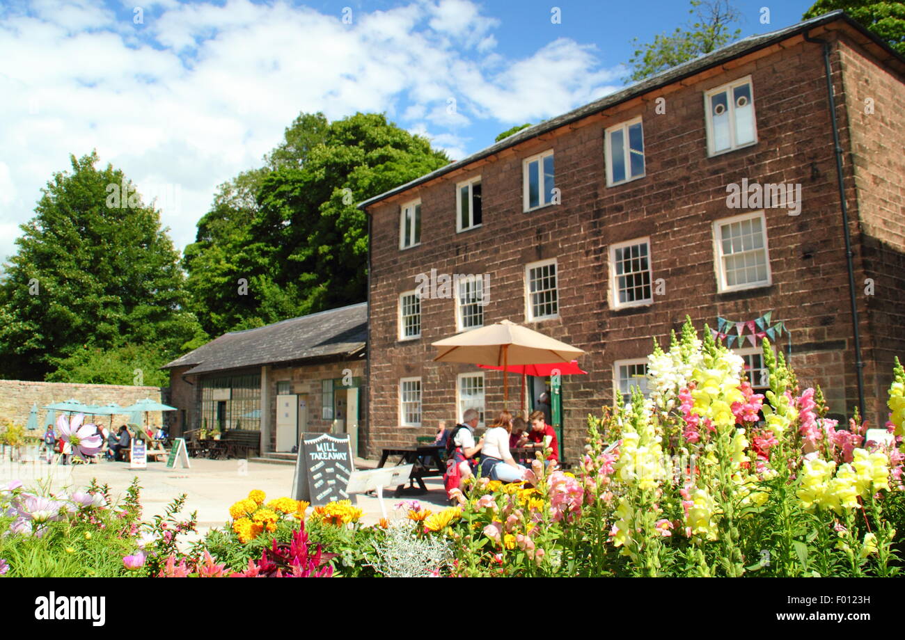 Visitors relax by the shops and cafe at Sir Richard Arkwright's Cromford Mills complex, Matlock, Derbyshire, England UK Stock Photo