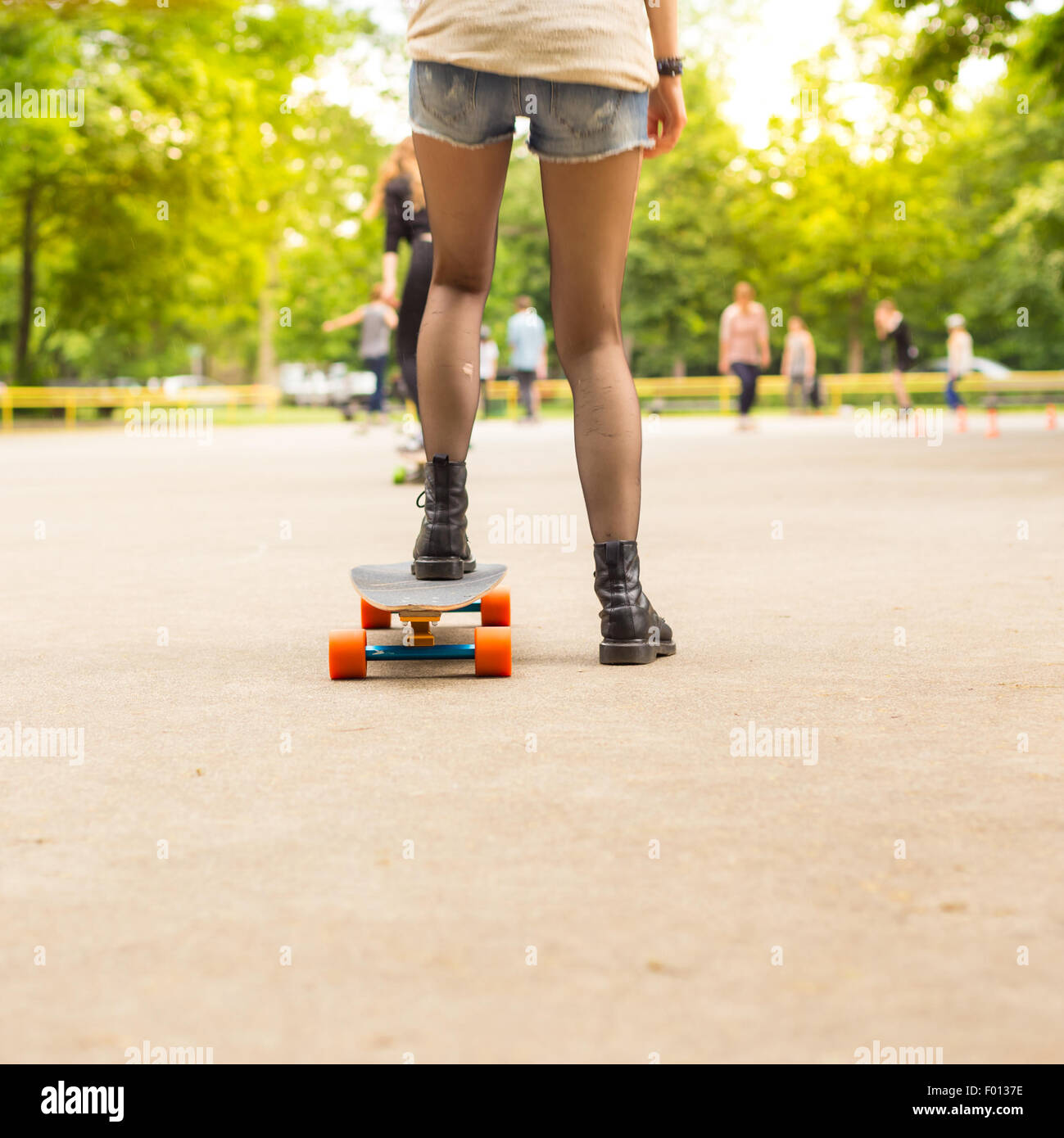 Teenage girl urban long board riding Stock Photo - Alamy