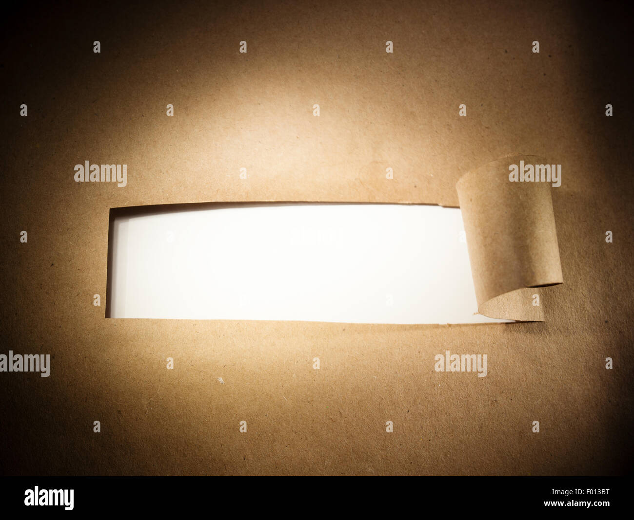 Torn brown paper with blank white space. Stock Photo
