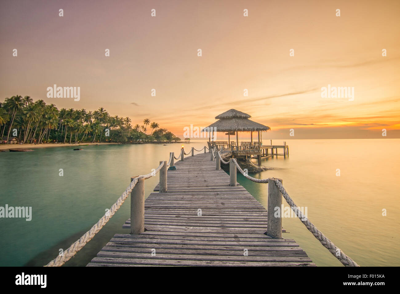 Summer, Travel, Vacation and Holiday concept - Wooden pier between sunset in Phuket, Thailand Stock Photo