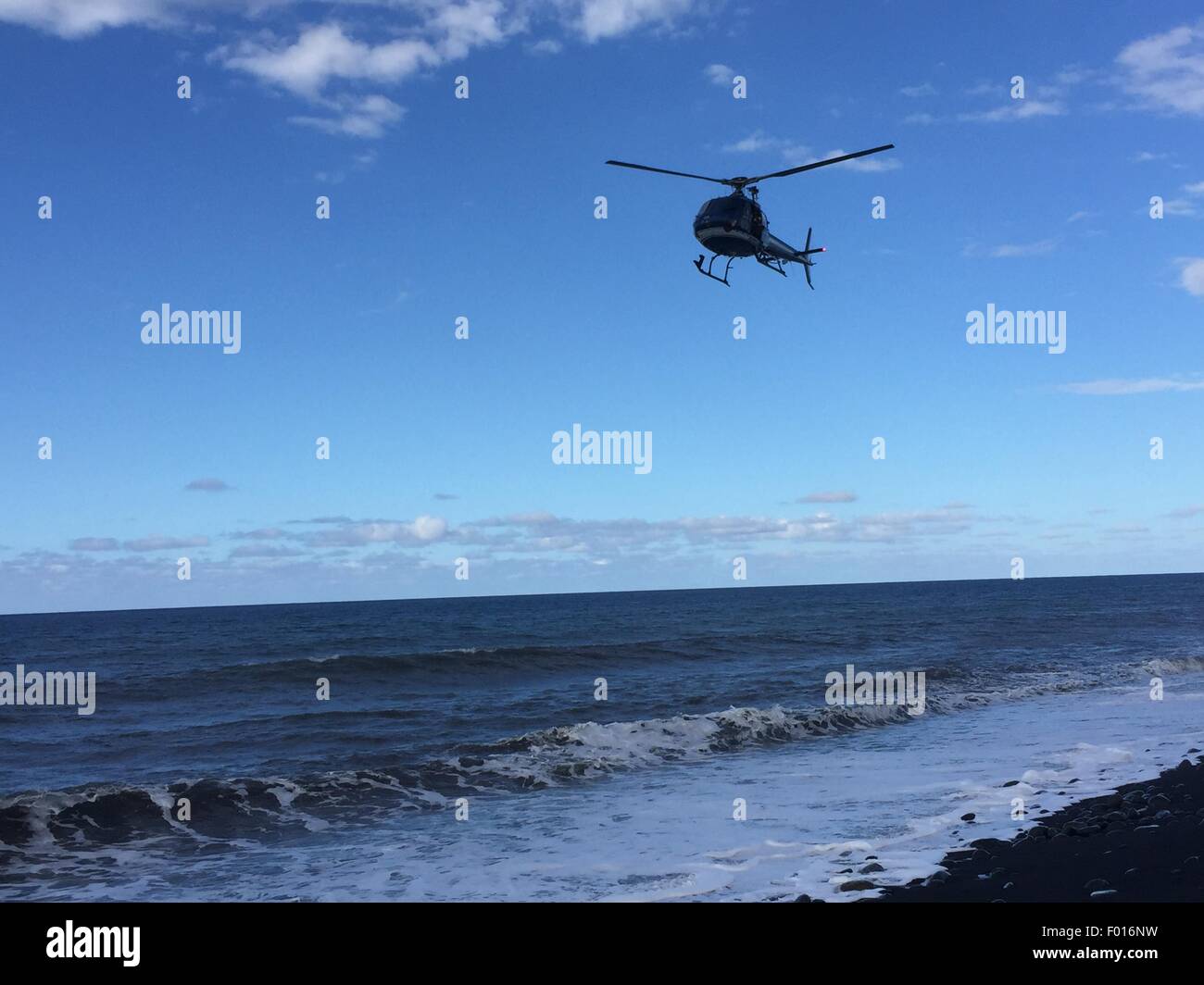 The Reunion Island. 30th July, 2015. A helicopter searchs over the sea on Reunion Island, on Jul.30, 2015. Verification had confirmed that the debris discovered on Reunion Island belongs to missing Malaysian Airlines flight MH370, Malaysian Prime Minister Najib Razak announced early Thursday. © Romain Latournerie/Xinhua/Alamy Live News Stock Photo