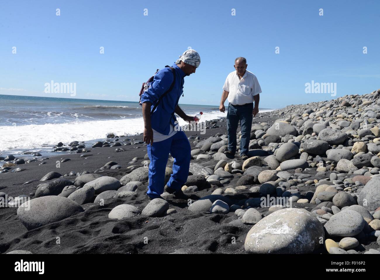 The Reunion Island. 31st July, 2015. People clean the beach of Reunion Island, on Jul.31, 2015. Verification had confirmed that the debris discovered on Reunion Island belongs to missing Malaysian Airlines flight MH370, Malaysian Prime Minister Najib Razak announced early Thursday. © Dong Ruifeng/Xinhua/Alamy Live News Stock Photo