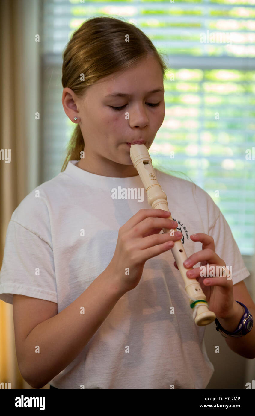 Young Girl (Eleven Years Old) Practicing Playing the Recorder.  MR Stock Photo