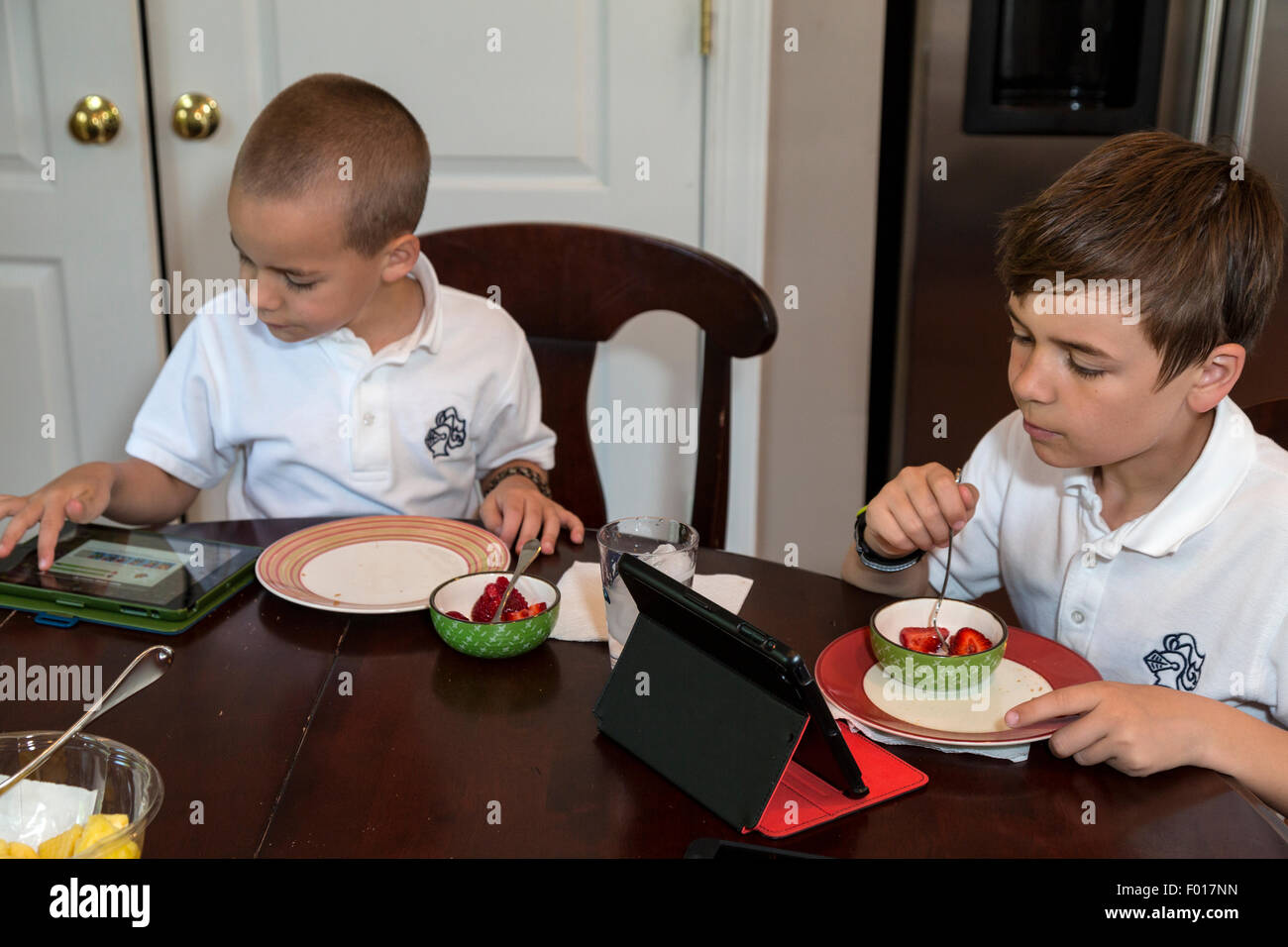 The Modern Child:  Breakfast with Video Games.  MR Stock Photo