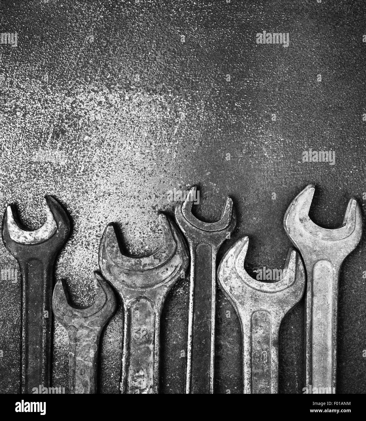 Old wrenches on a metal table, bw photo Stock Photo