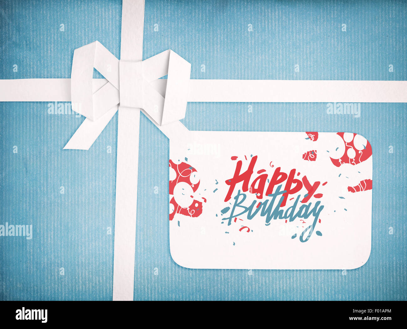 Gift ribbon and bow with Happy birthday lettering on gift tag Stock Photo