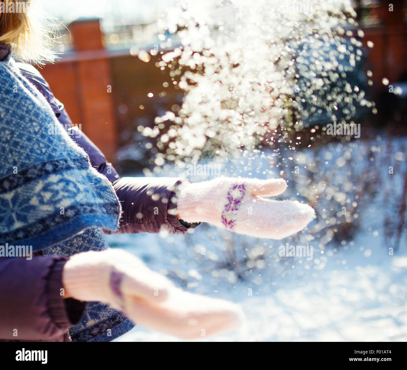 Women playing with snow in sunny winter day, small dof photo Stock Photo