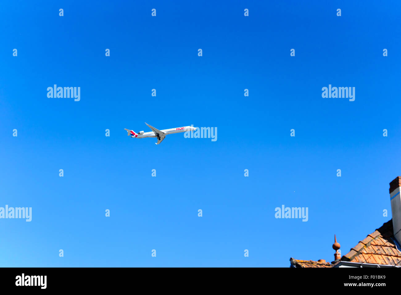 modern jet passenger aircraft flying in blue sky Stock Photo - Alamy
