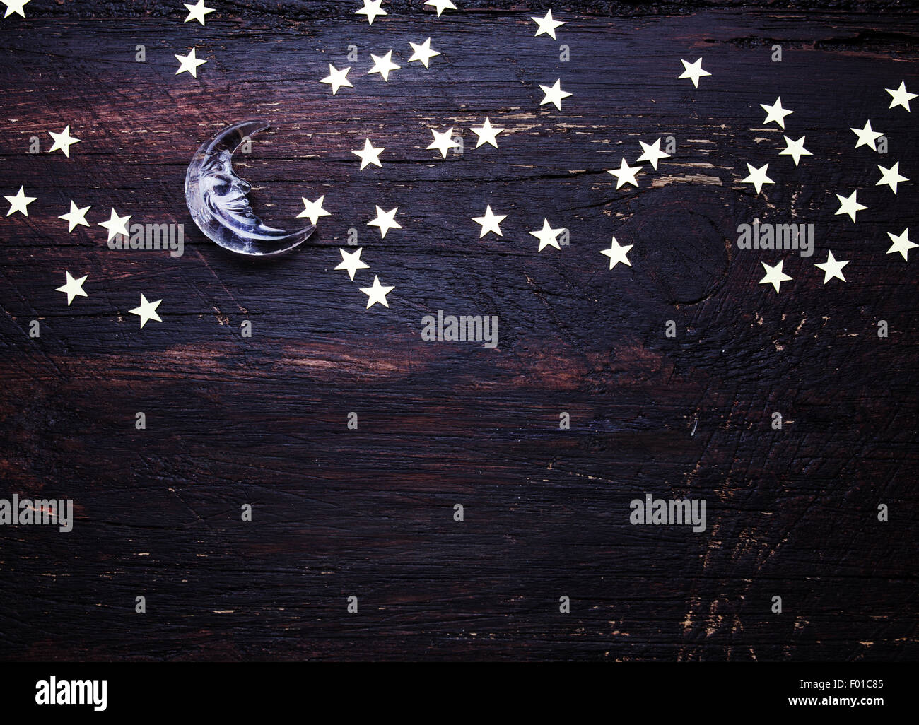 Glitter golden stars and glass moon on grunge wood background. Black and white photo Stock Photo