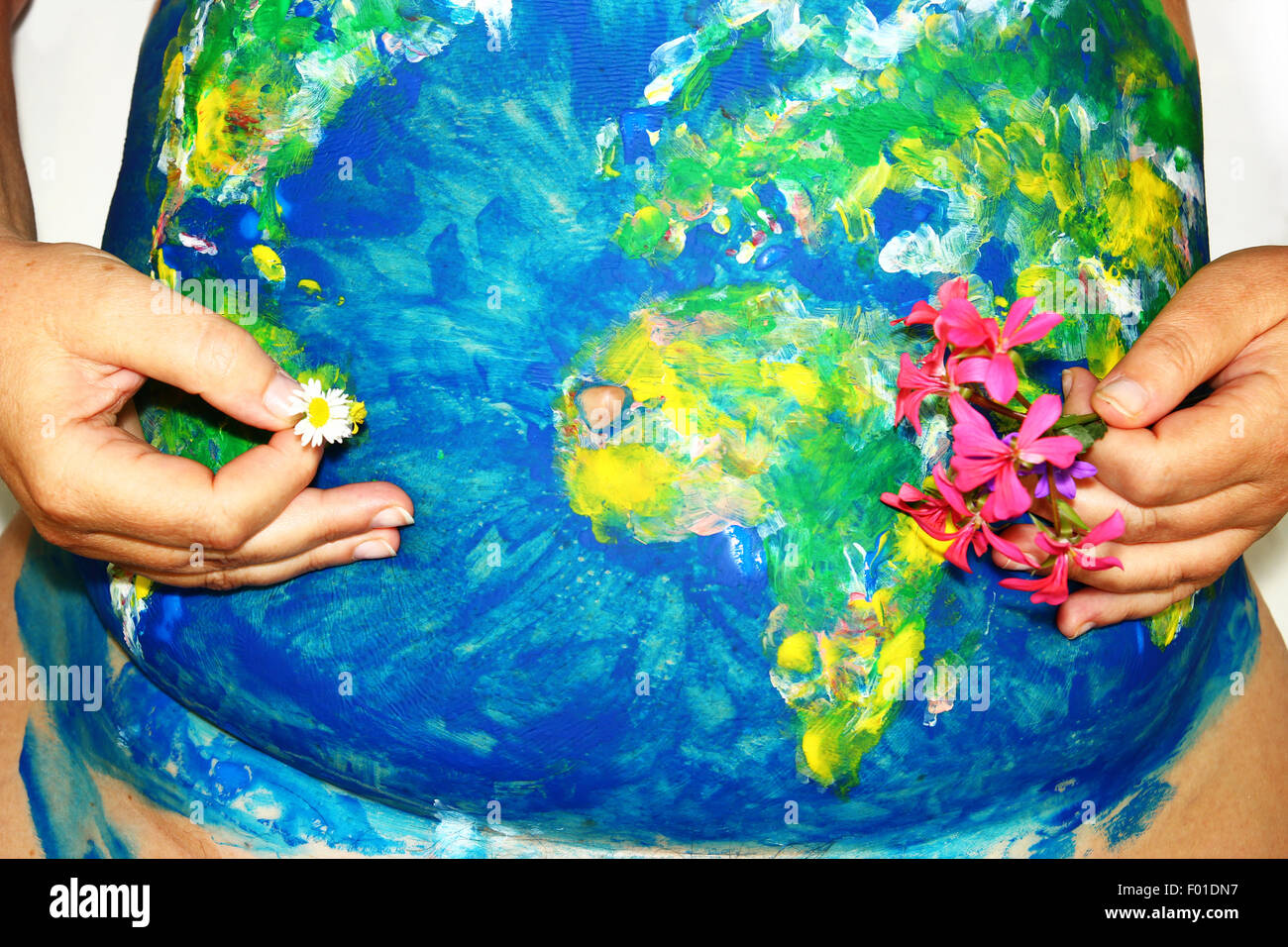 Earth Mother concept, globe body paint on a female pregnant belly Stock