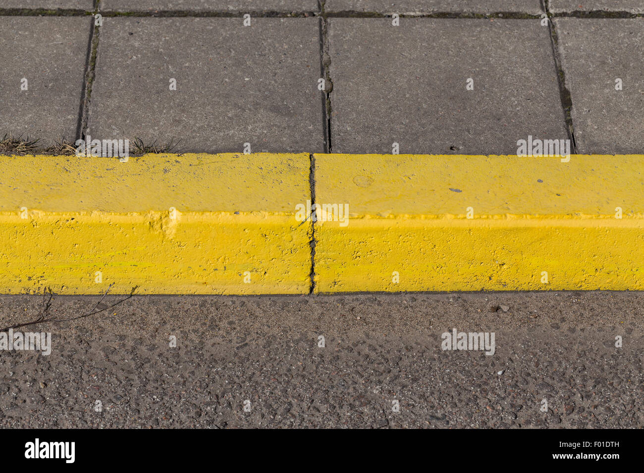 Yellow curb stone border and asphalt road Stock Photo Alamy