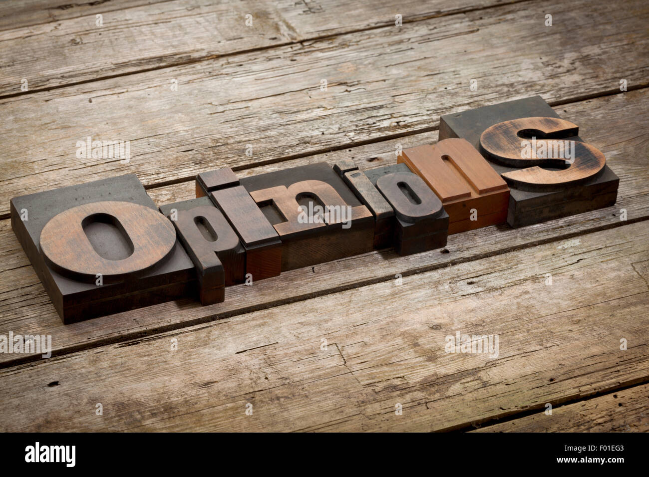 opinions, word written with vintage letterpress printing blocks, angled view, rustic wooden background Stock Photo