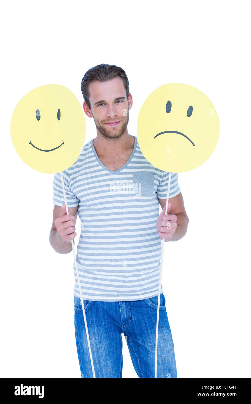 Handsome man holding smiley faces Stock Photo
