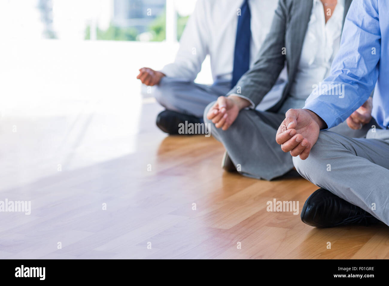 Close up view of business people doing yoga Stock Photo - Alamy