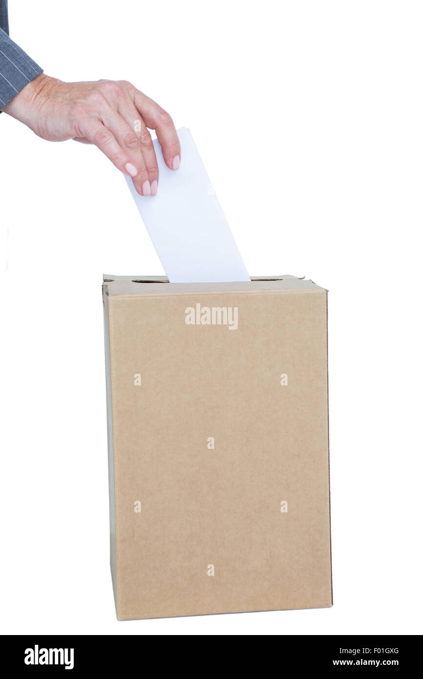 Businessman putting ballot in vote box Stock Photo