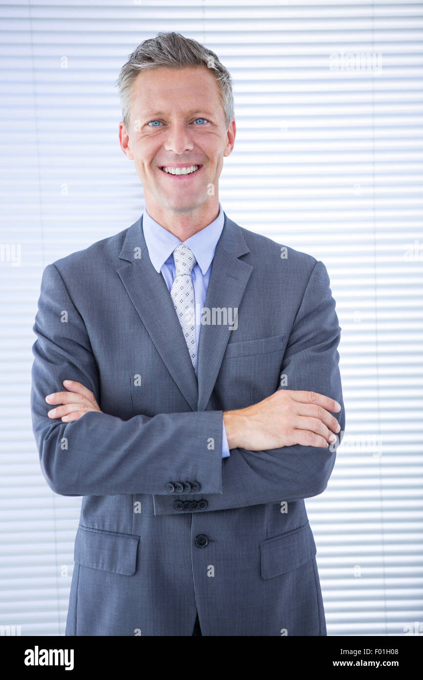 Smiling businessman with arms crossed Stock Photo - Alamy