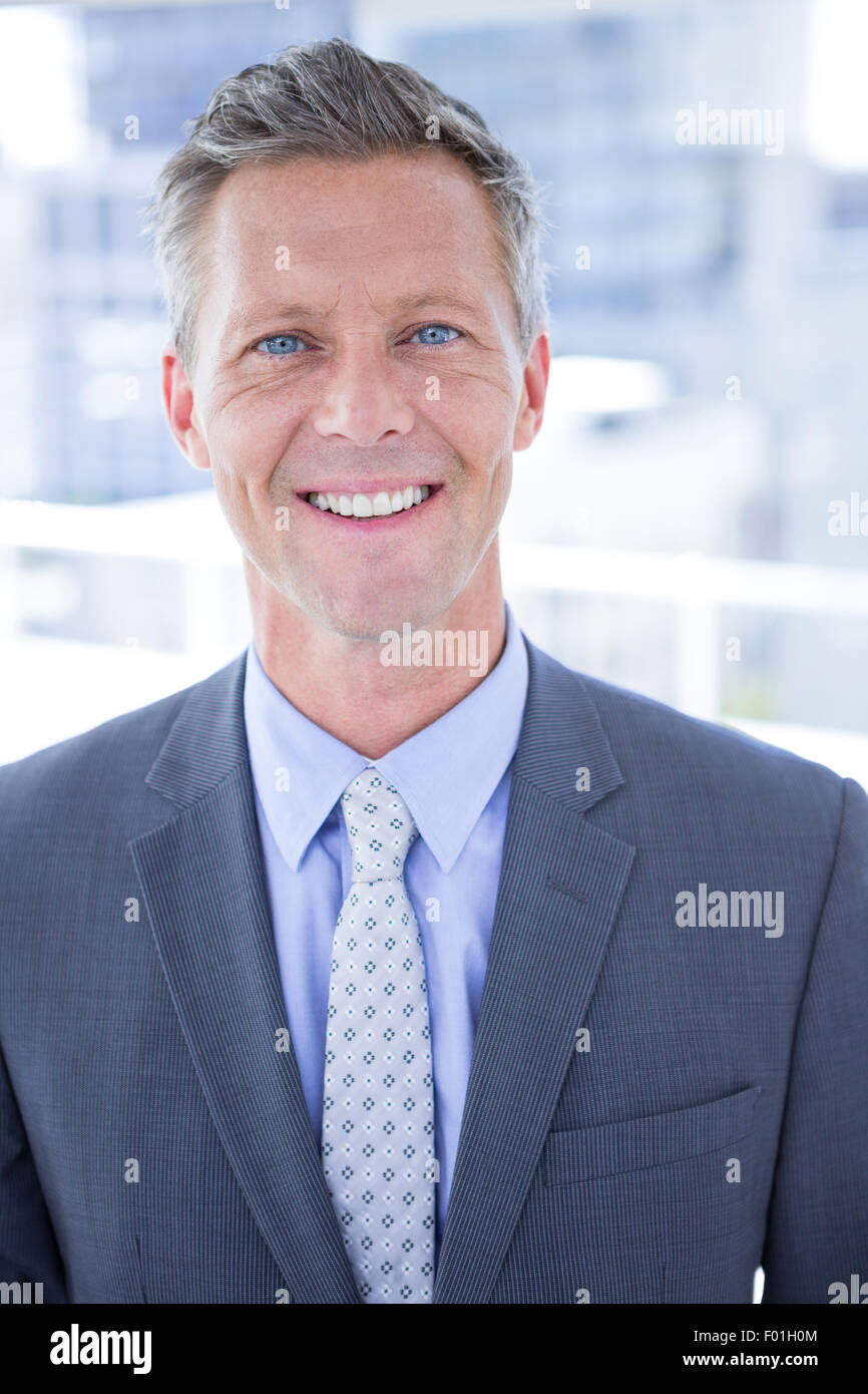 Smiling businessman looking at camera Stock Photo - Alamy