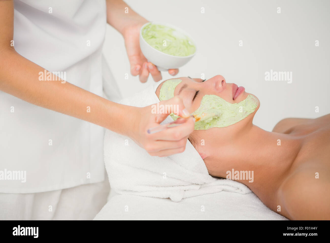 Beautiful brunette getting a facial treatment Stock Photo