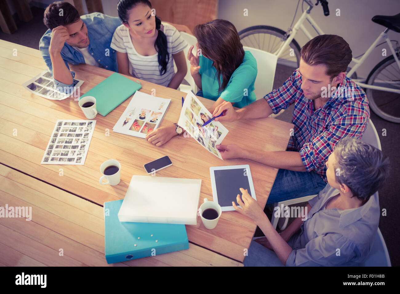 Seated creative business team working together Stock Photo - Alamy