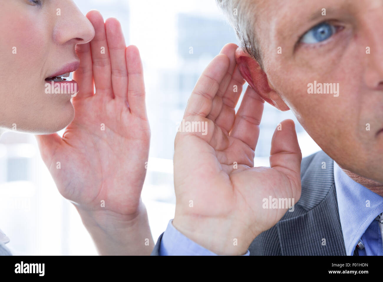 Business colleagues whispering Stock Photo