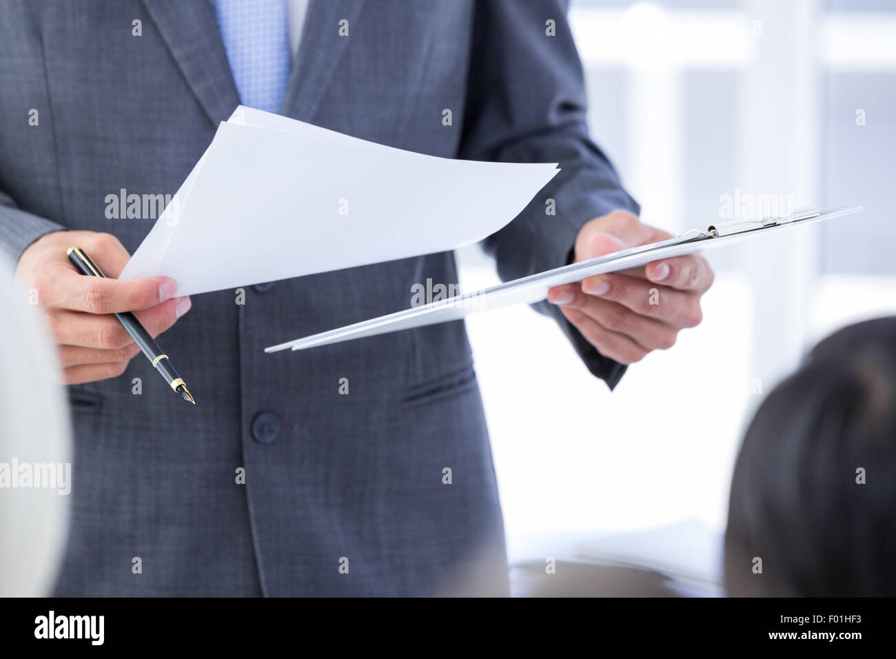 Business team taking notes during conference Stock Photo