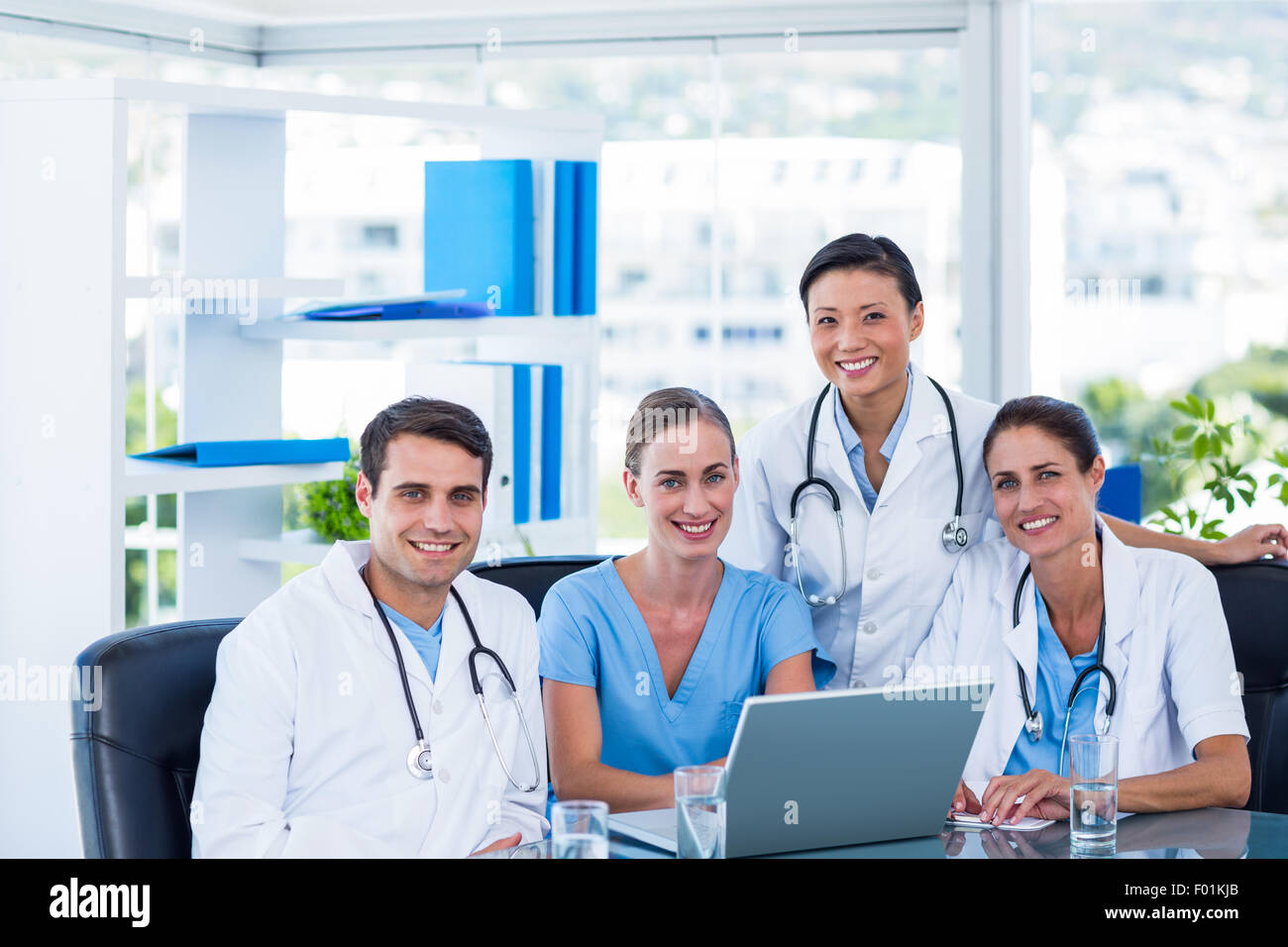 Medical team discussing smiling camera hi-res stock photography and ...