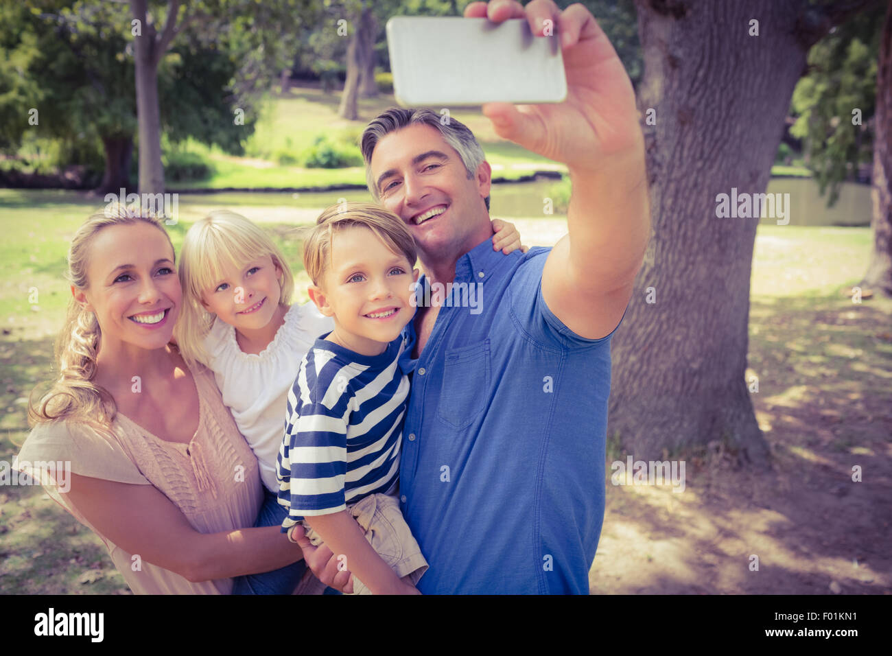 Happy family taking a selfie in the park Stock Photo - Alamy