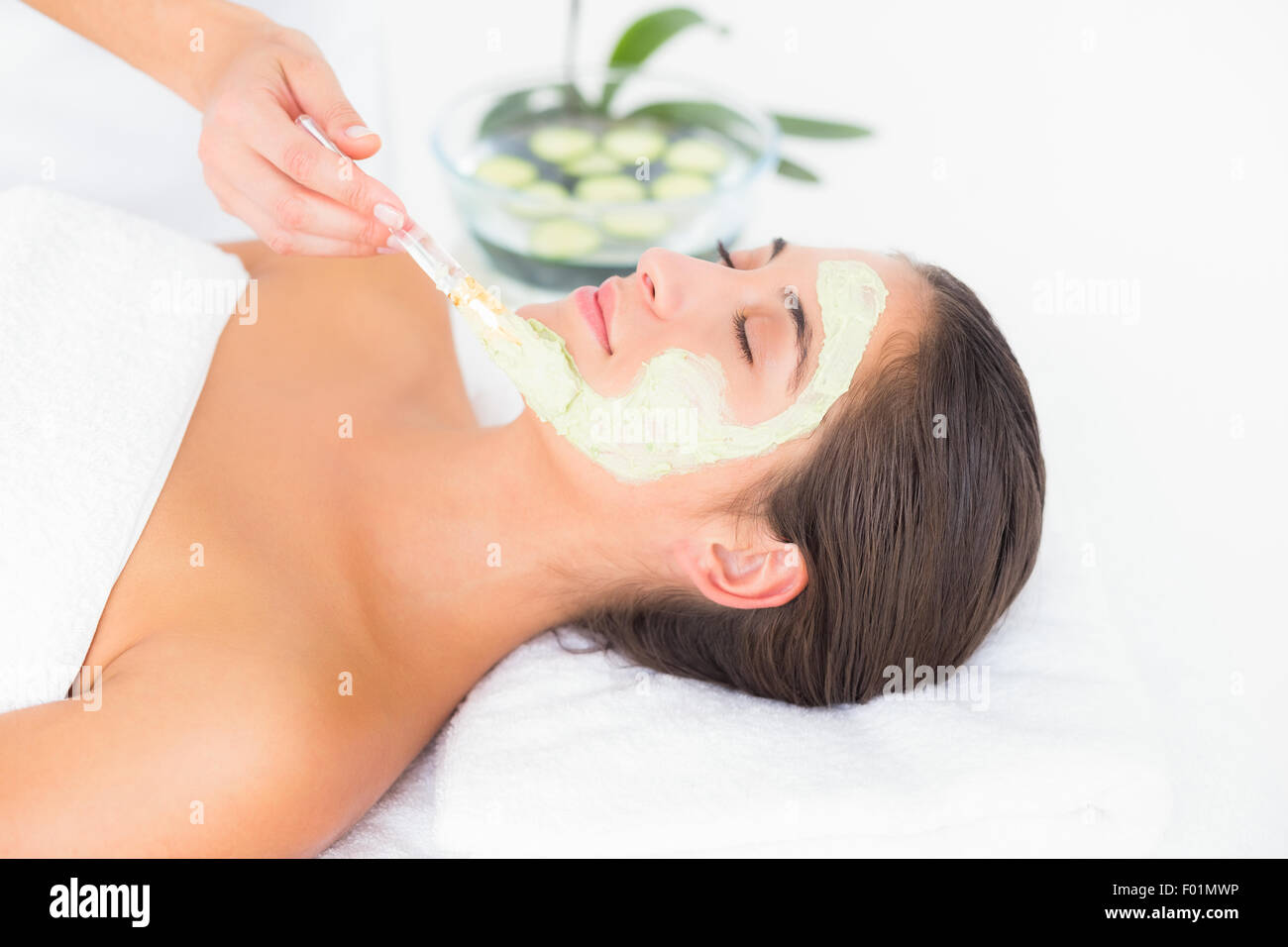 Beautiful brunette getting a facial treatment Stock Photo - Alamy