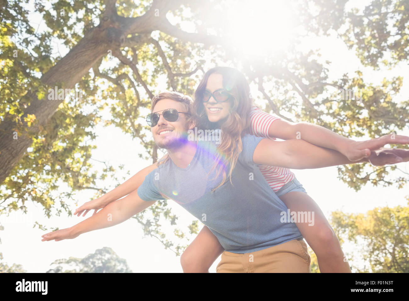 Cute couple having fun in park Stock Photo - Alamy