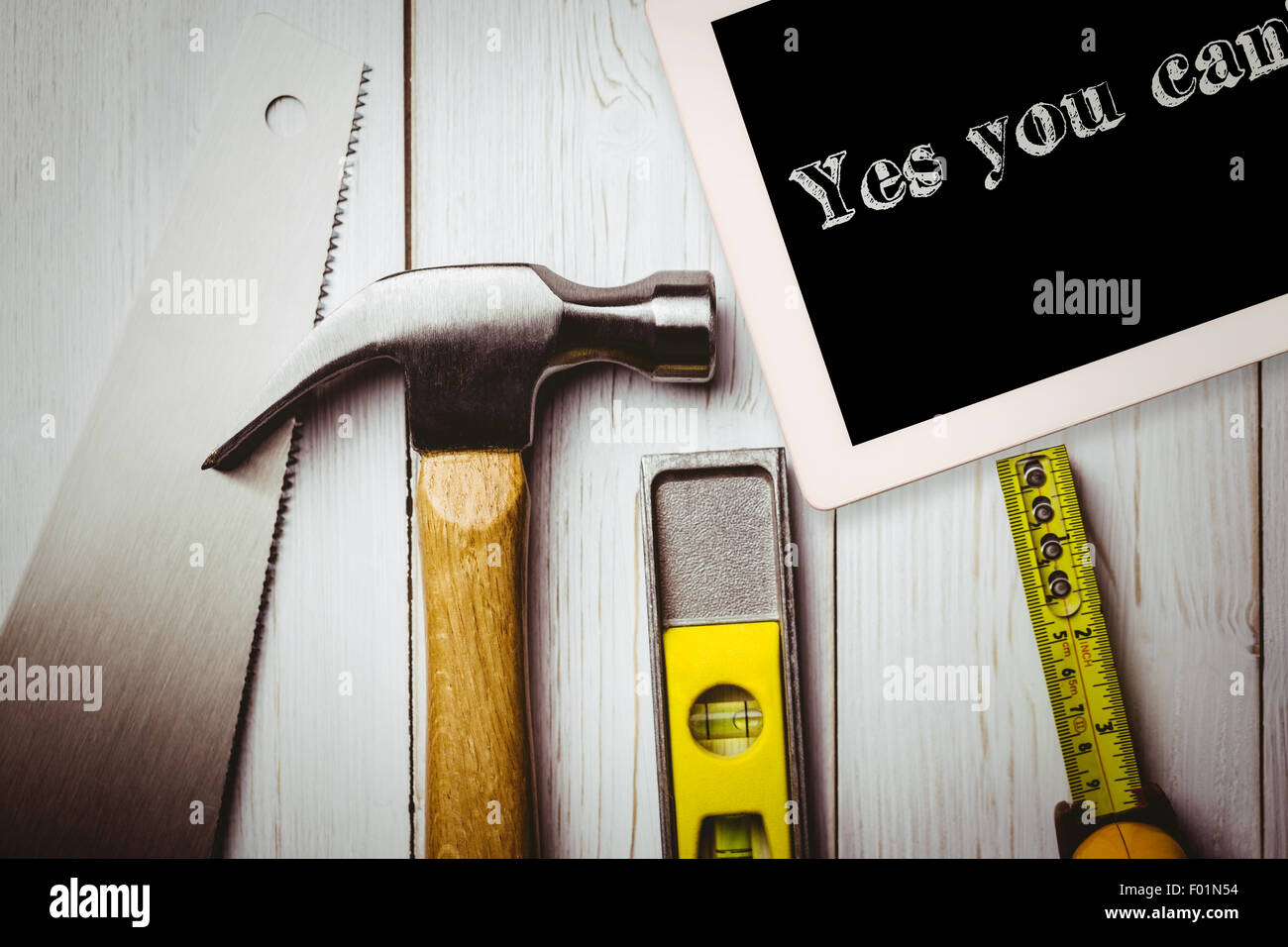 Yes you can! against desk with tools Stock Photo