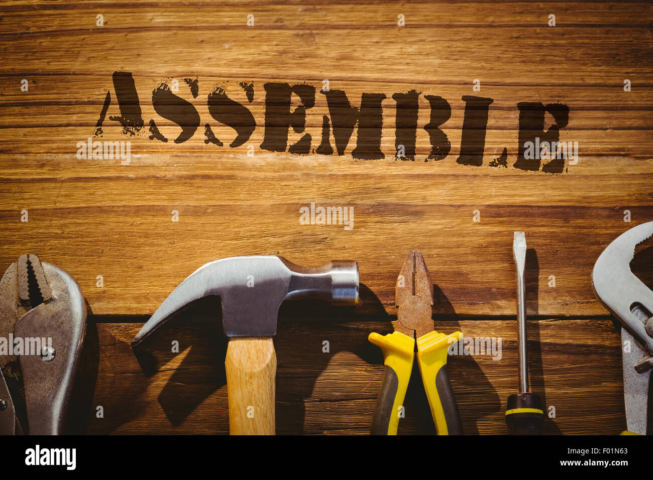 Assemble against desk with tools Stock Photo