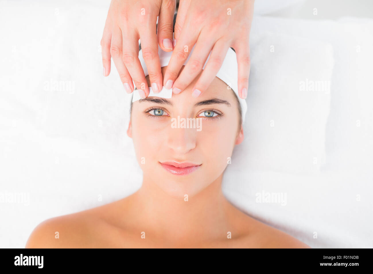 Hand waxing beautiful womans eyebrow Stock Photo Alamy