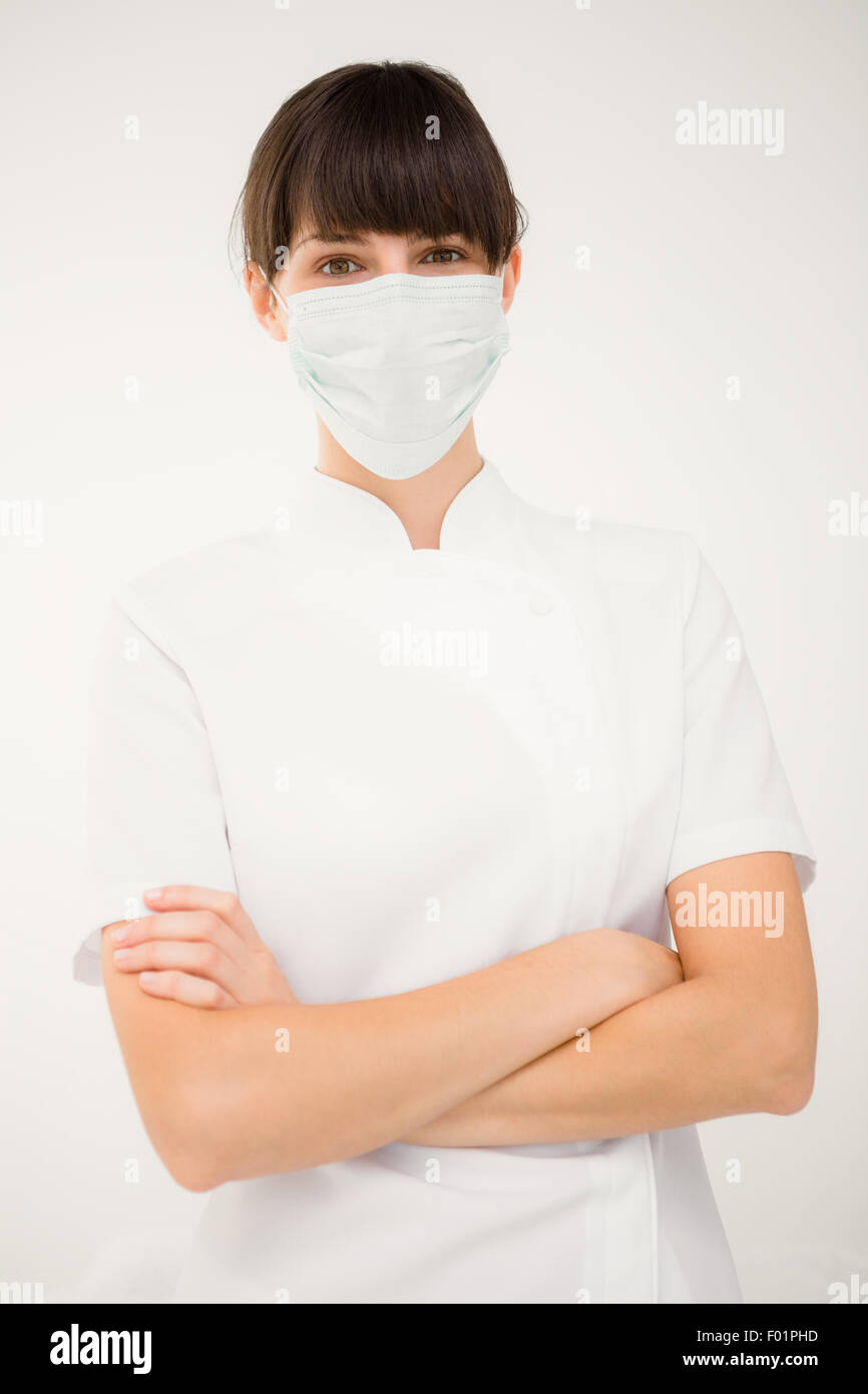 Nurse wearing protective mask with arms crossed Stock Photo