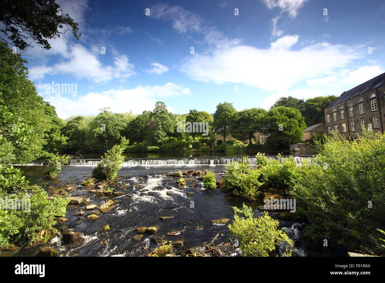 Bamford Mill and weir on the River Derwent in the Peak District National Park, England, UK Stock Photo