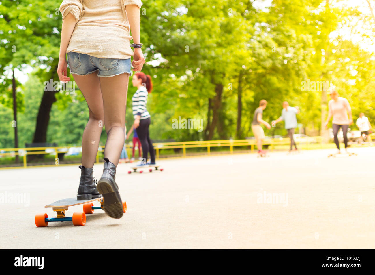Teenage girl urban long board riding Stock Photo - Alamy
